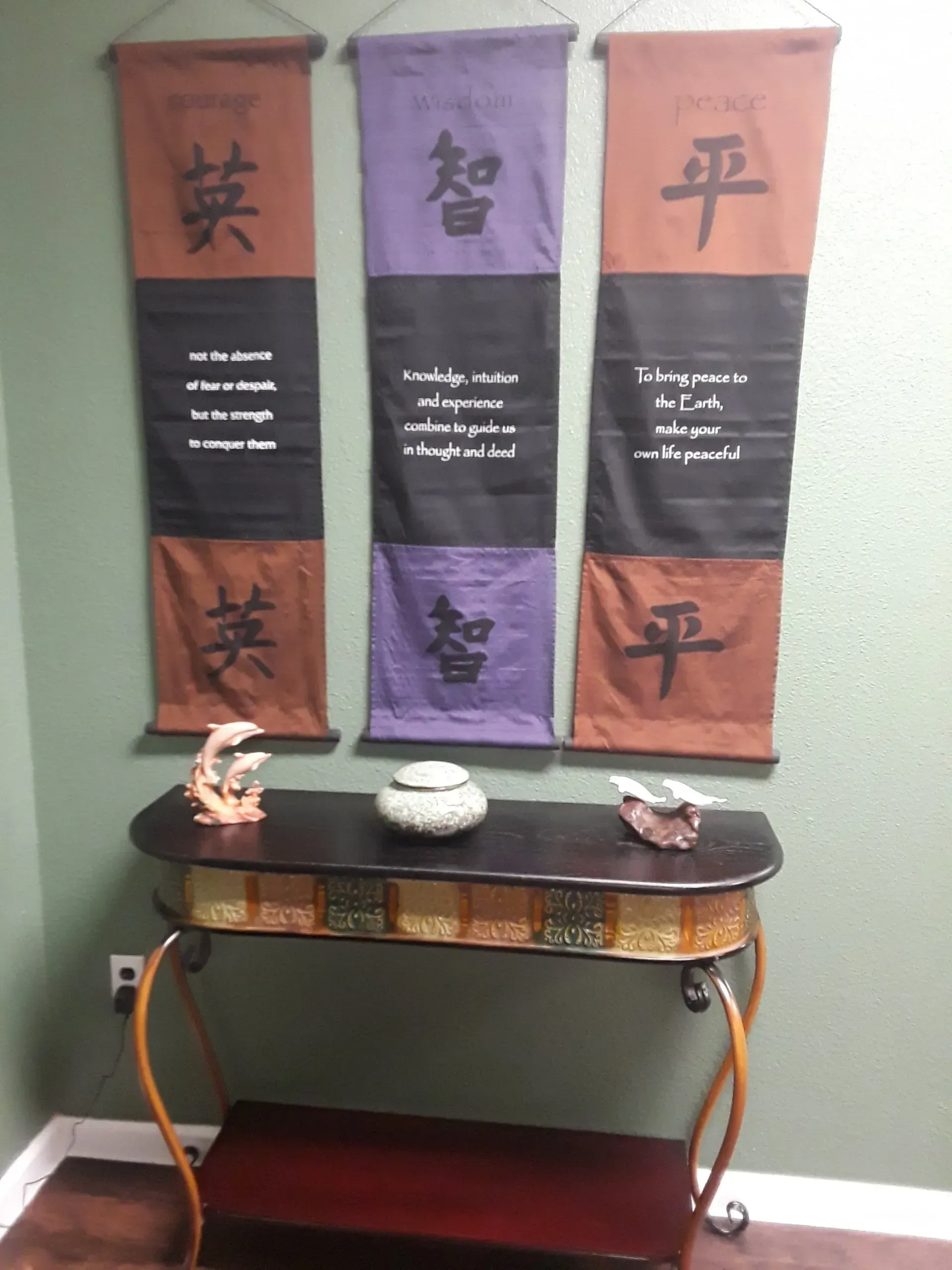 A table with three banners hanging on the wall above it