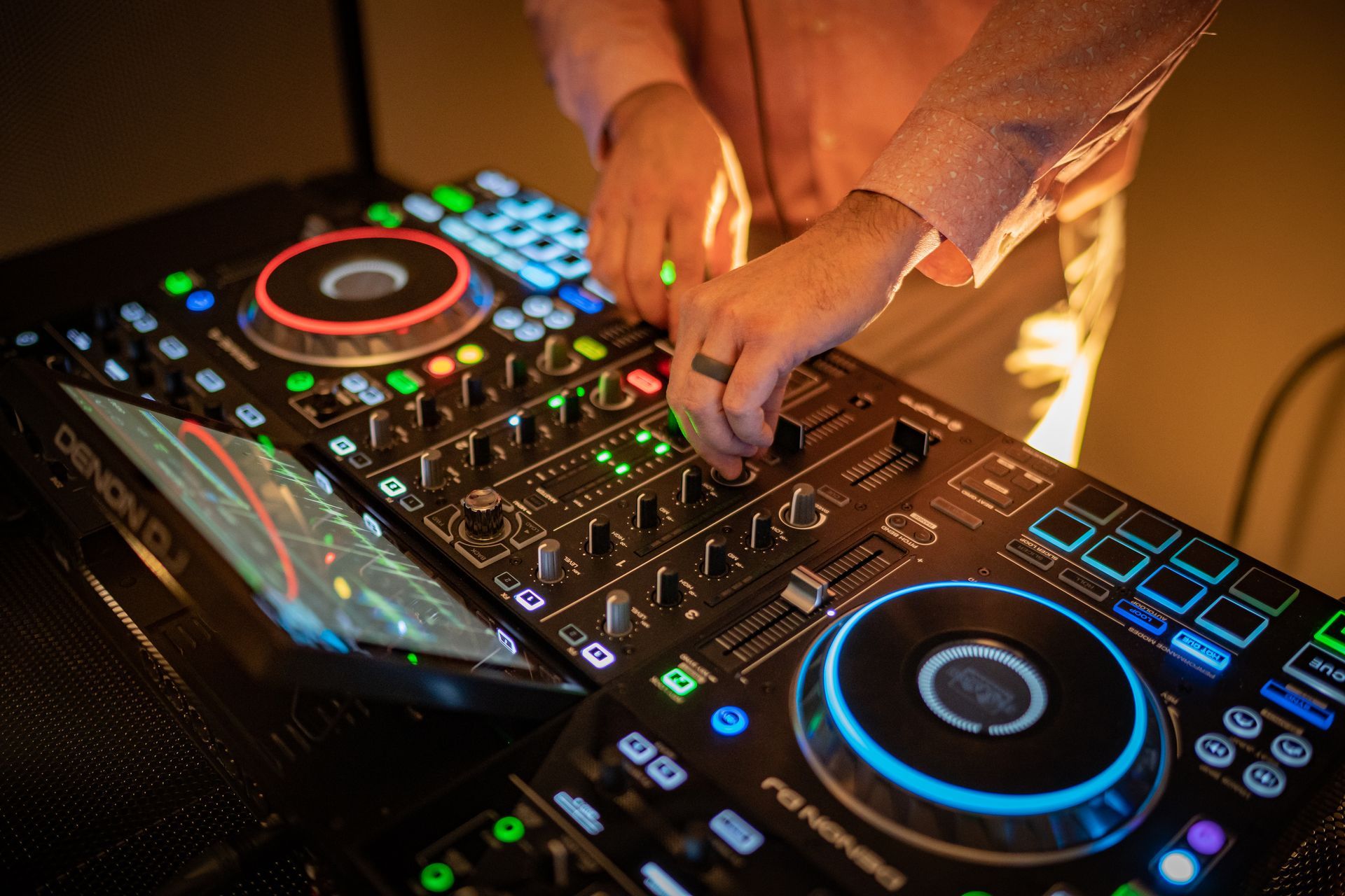 A person is playing music on a dj controller.
