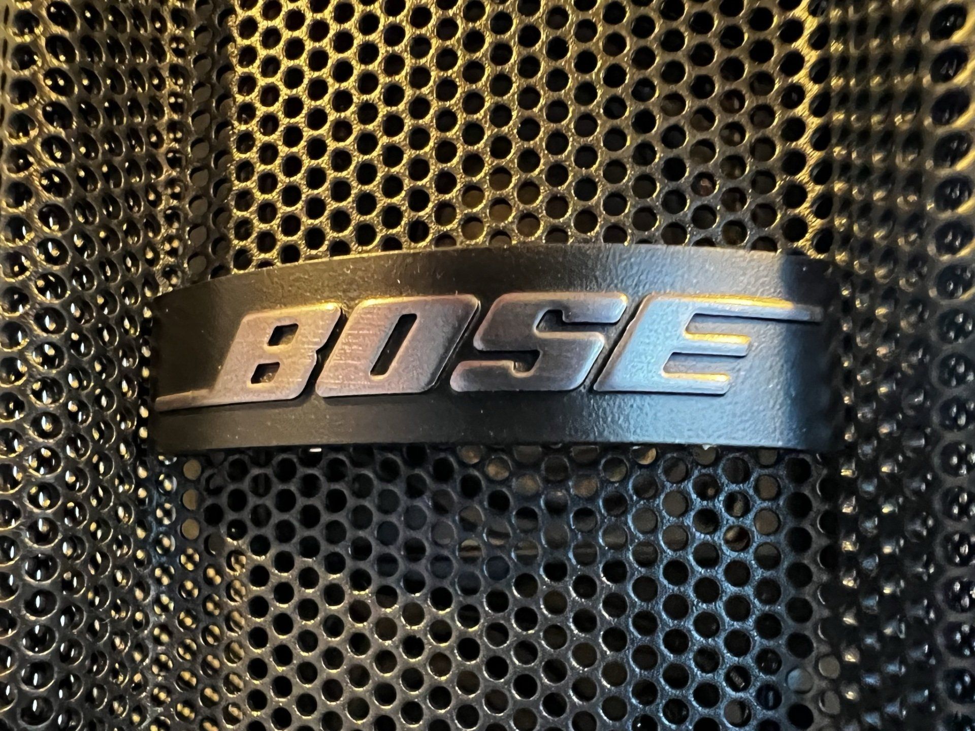 A close up of a bose logo on a speaker