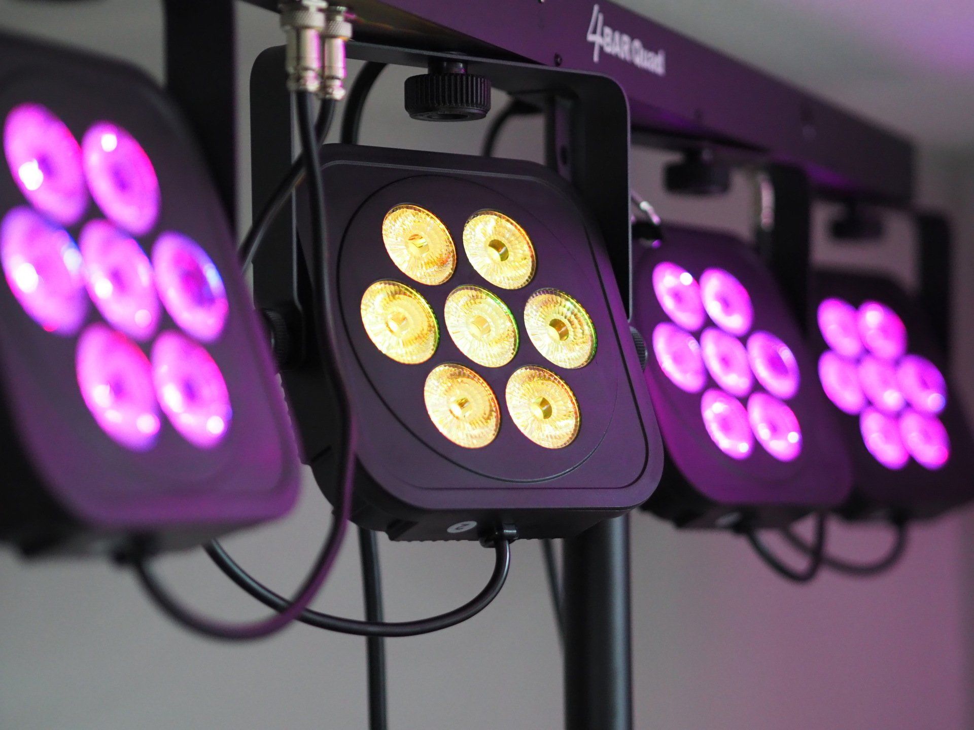 A row of purple and yellow lights on a stand