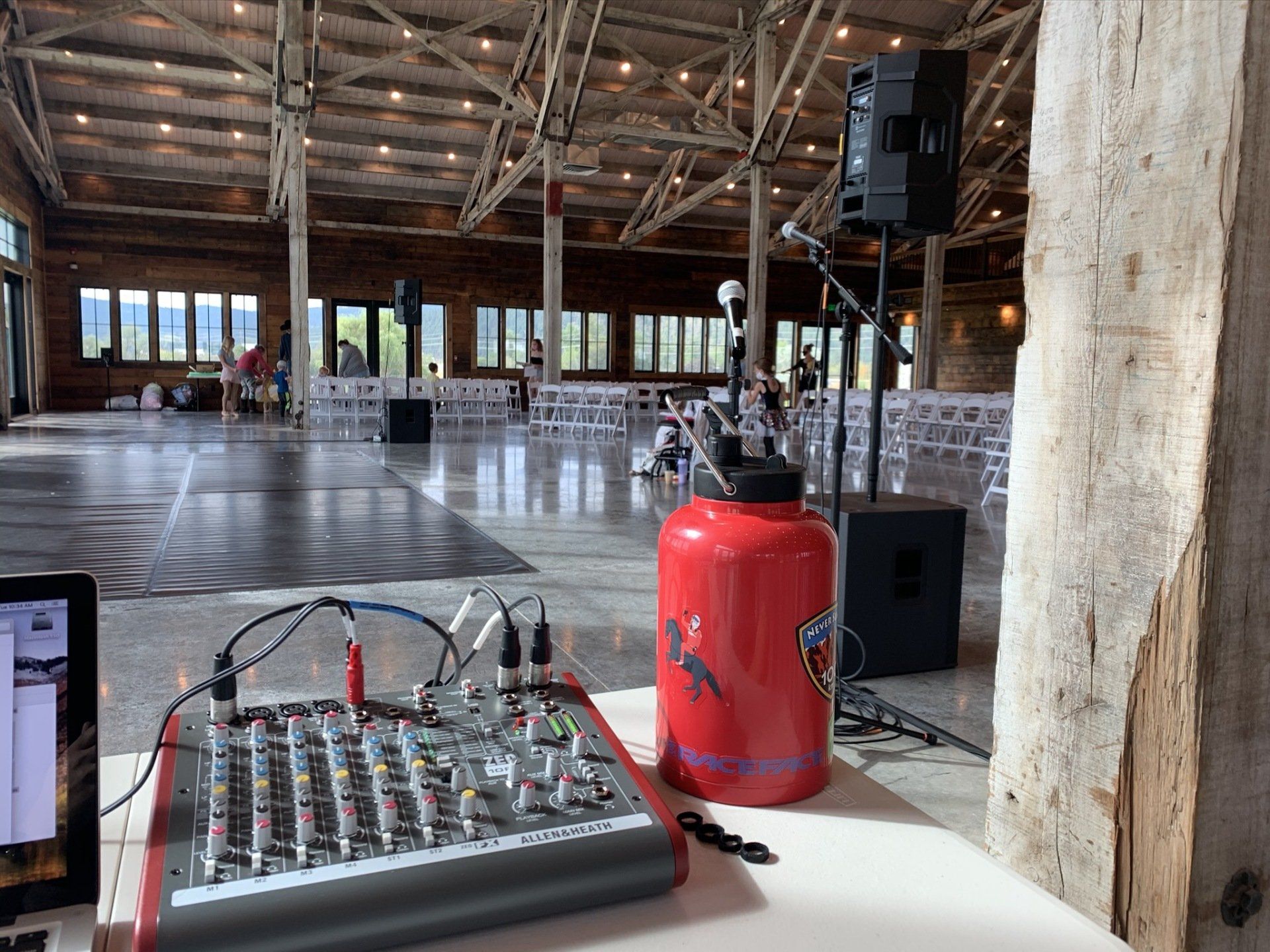 A mixer is sitting on a table in a large room.