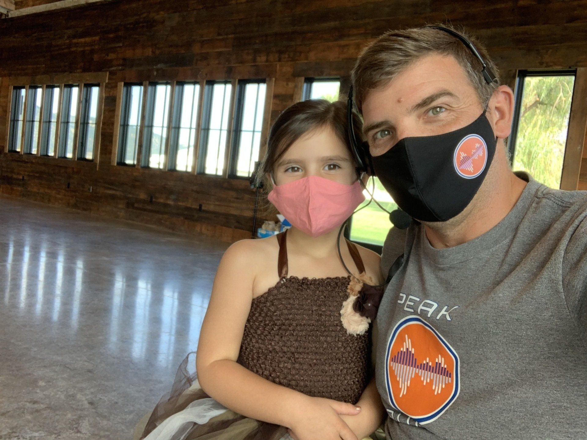 A man and a little girl wearing face masks