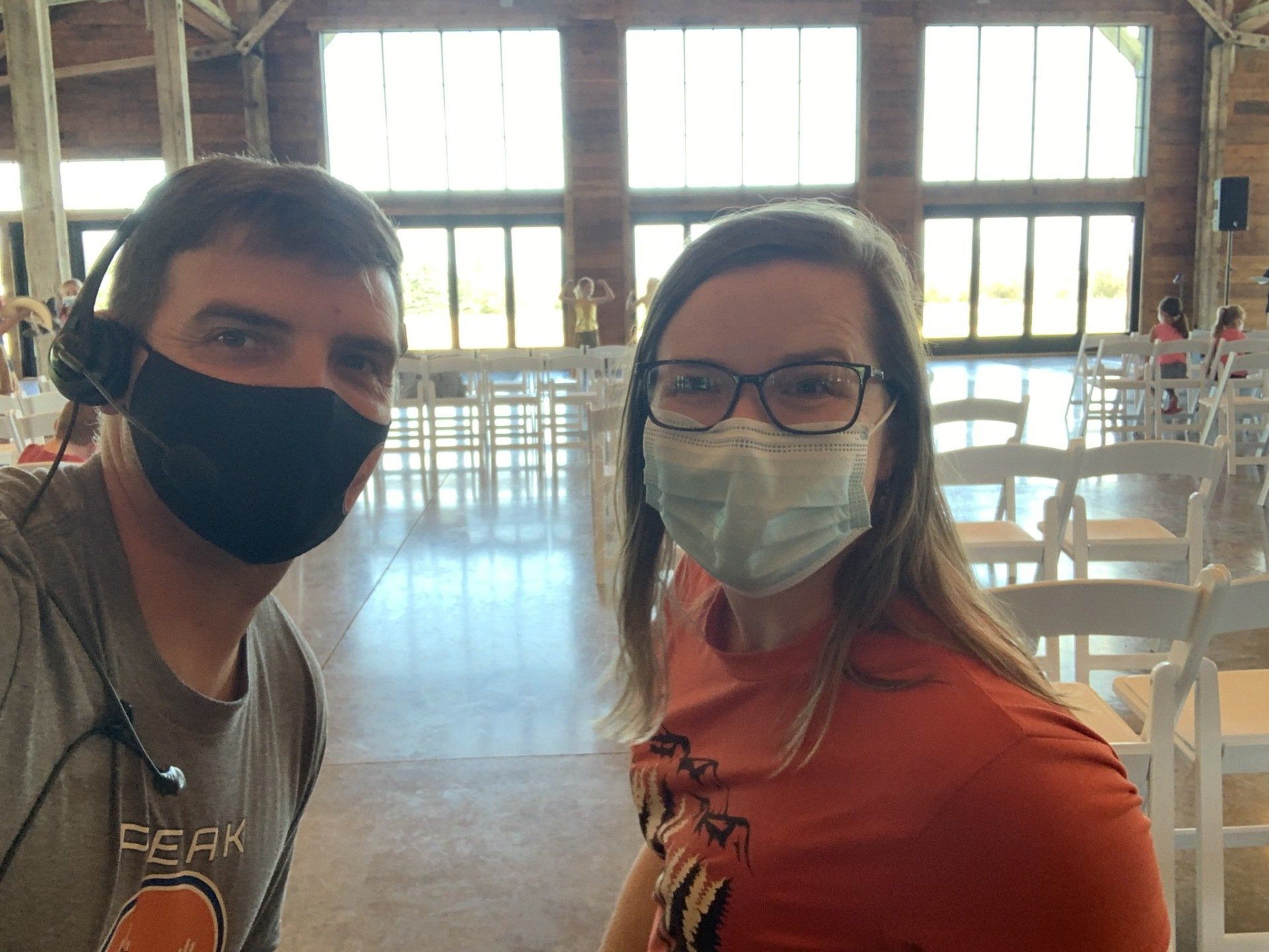 A man and a woman wearing face masks are posing for a picture.