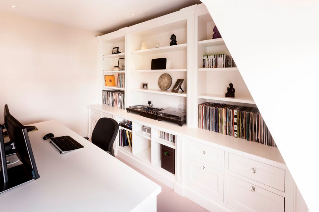AD Construction NJ - Built-in white shelves and cabinets in a home office with a desk and computer.