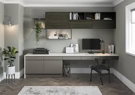 AD Construction NJ - Modern home office with gray walls, built-in desk, shelving, computer, chair, and plants.