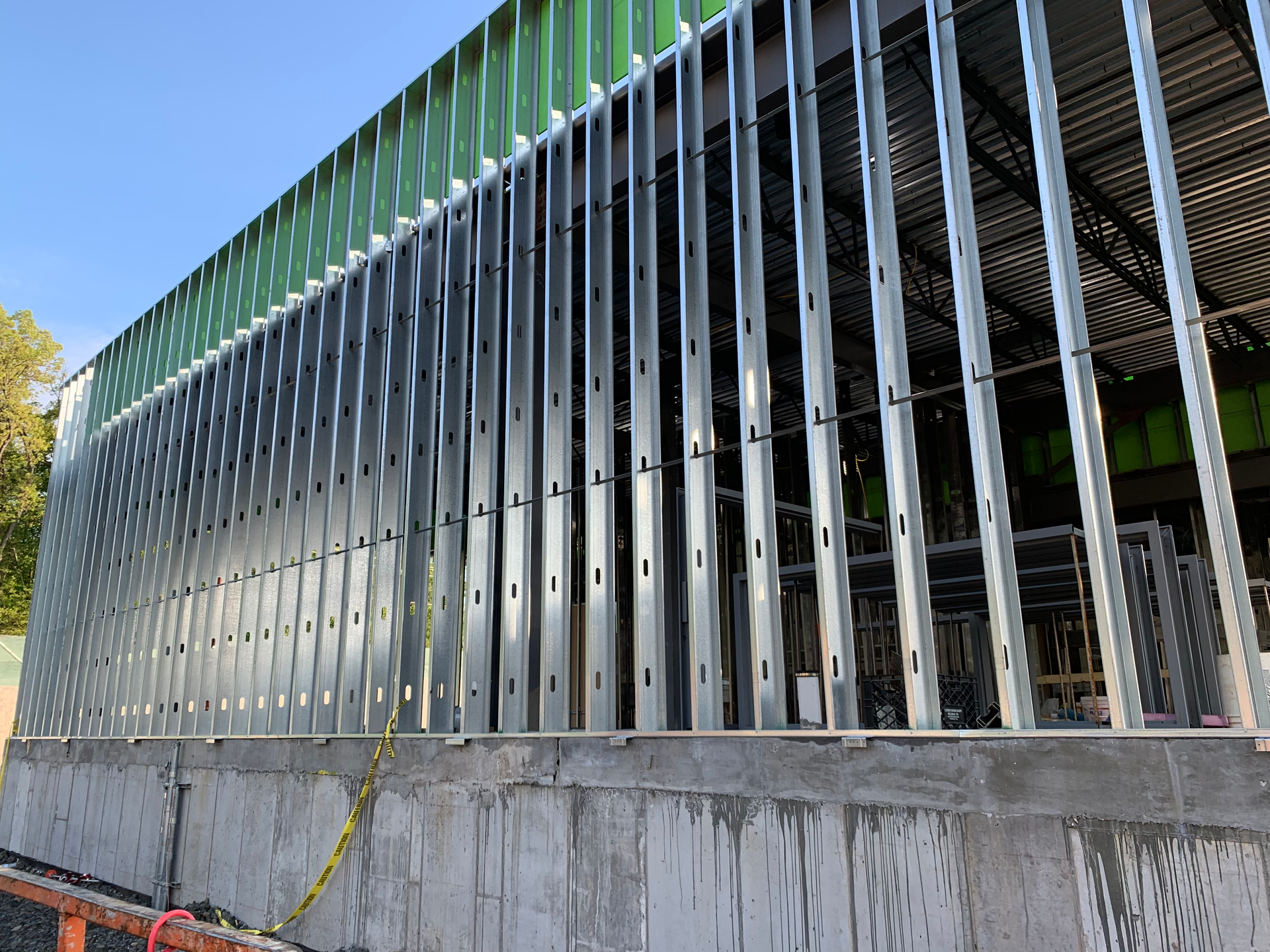 AD Construction NJ - Exterior of a building under construction, metal framing on a concrete base.