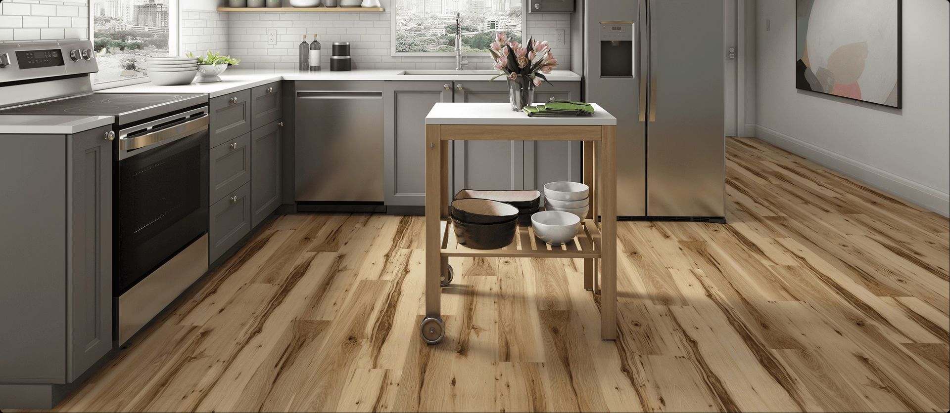 AD Construction NJ - A kitchen with wooden floors, grey cabinets, and a stainless steel stove and refrigerator.