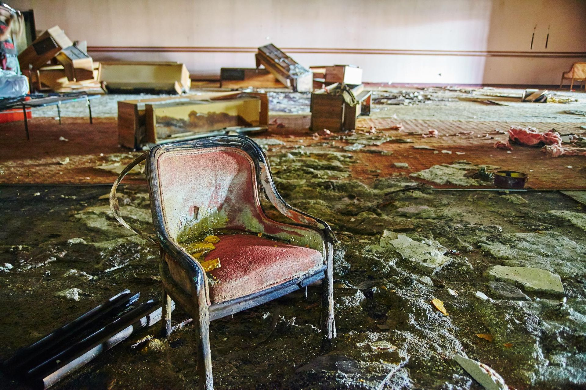 A chair is sitting in the middle of a messy room