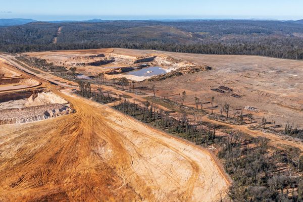 An aerial view of a dirt road going through a deserted area.