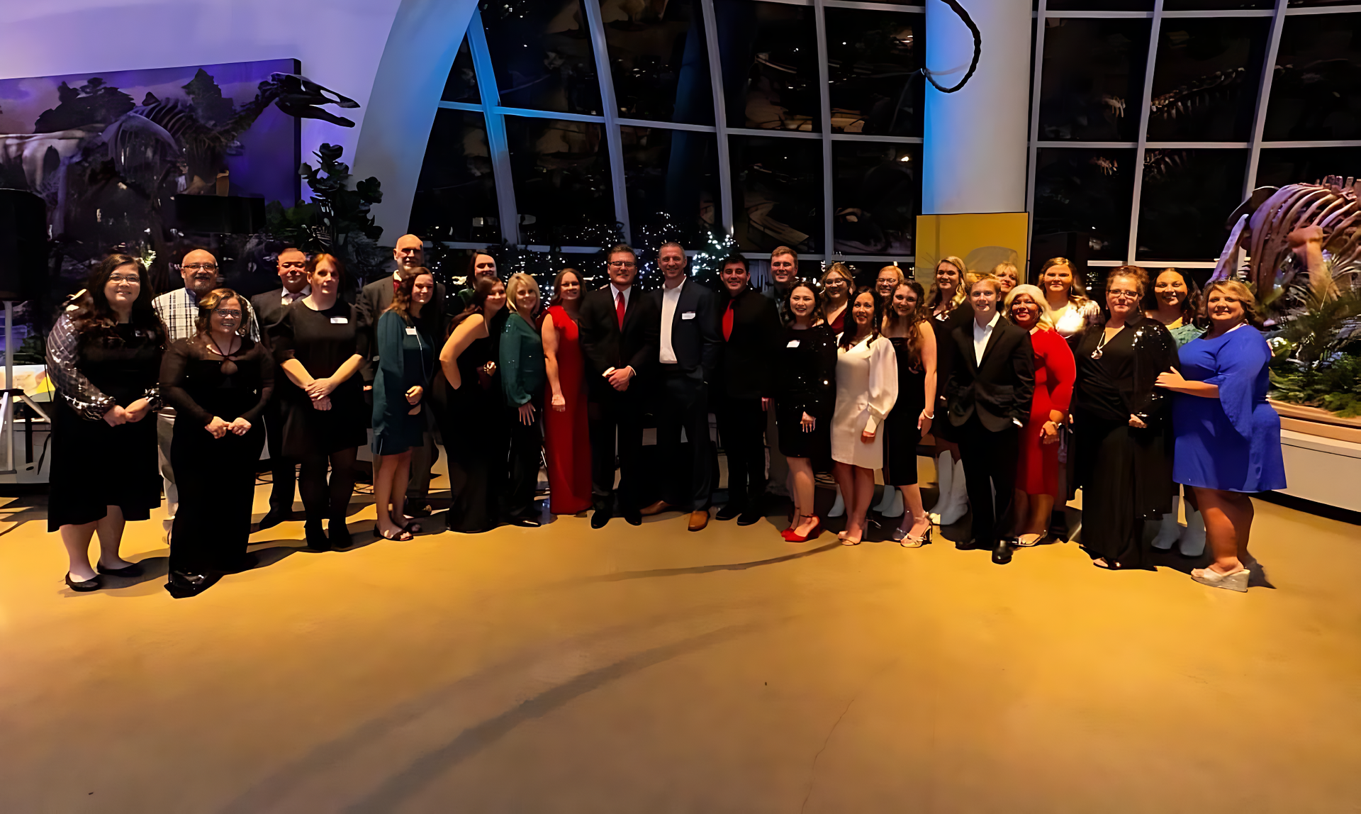A large group of people are posing for a picture in a room.