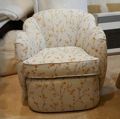 a white chair with a floral pattern on it