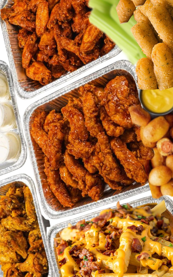 Buffet line with various dishes in silver chafing dishes, on a long, green-topped table.