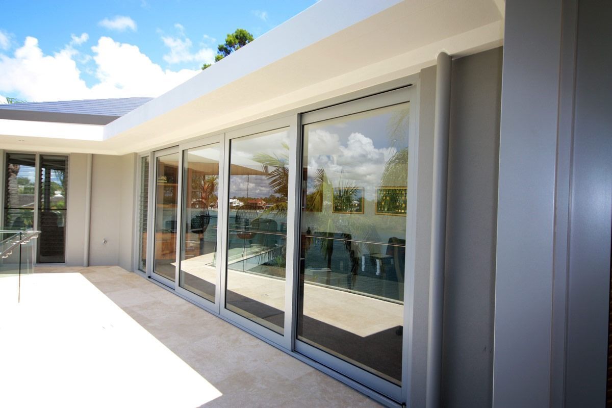 A House With A Lot Of Windows And A Patio — Datco Aluminium Pty Ltd In Murwillumbah, NSW