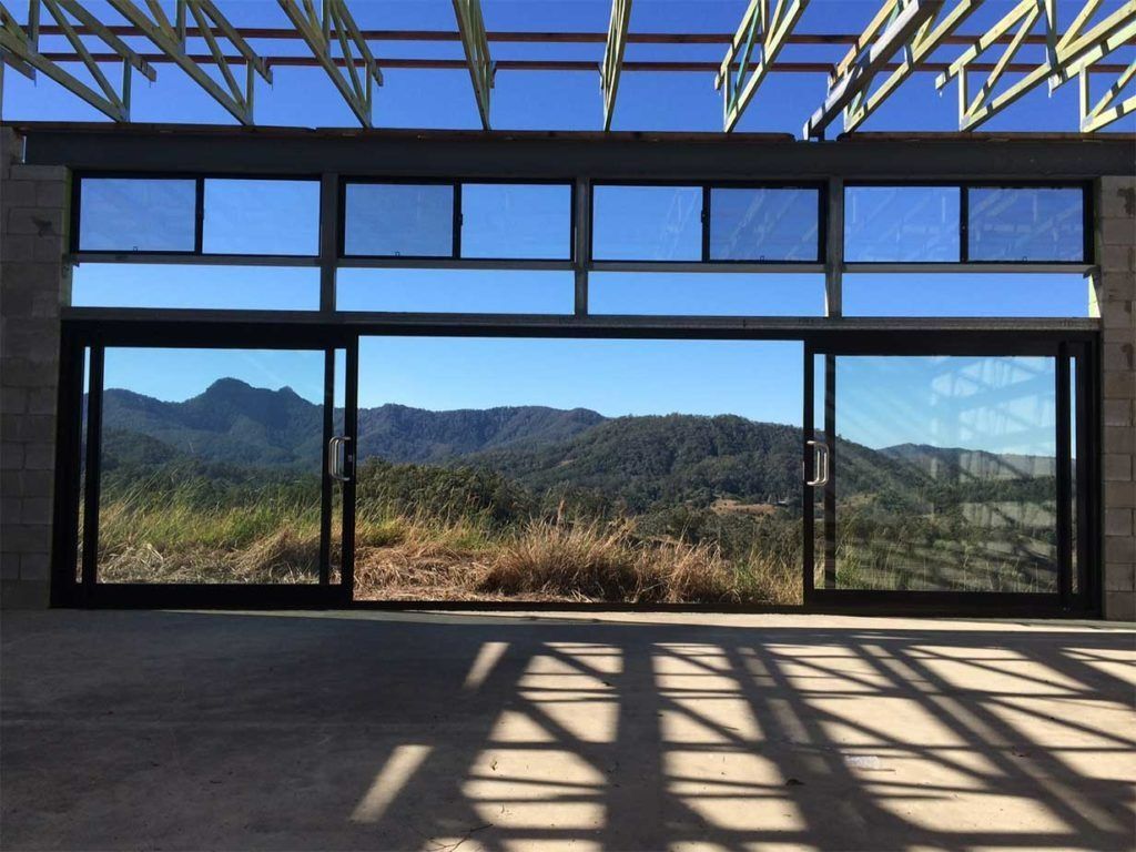 A Large Window With A View Of A Mountain Range — Datco Aluminium Pty Ltd In Tweed Coast, NSW