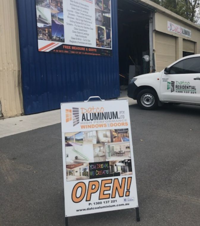 A Sign That Says Open In Front Of A Building — Datco Aluminium Pty Ltd In Murwillumbah, NSW