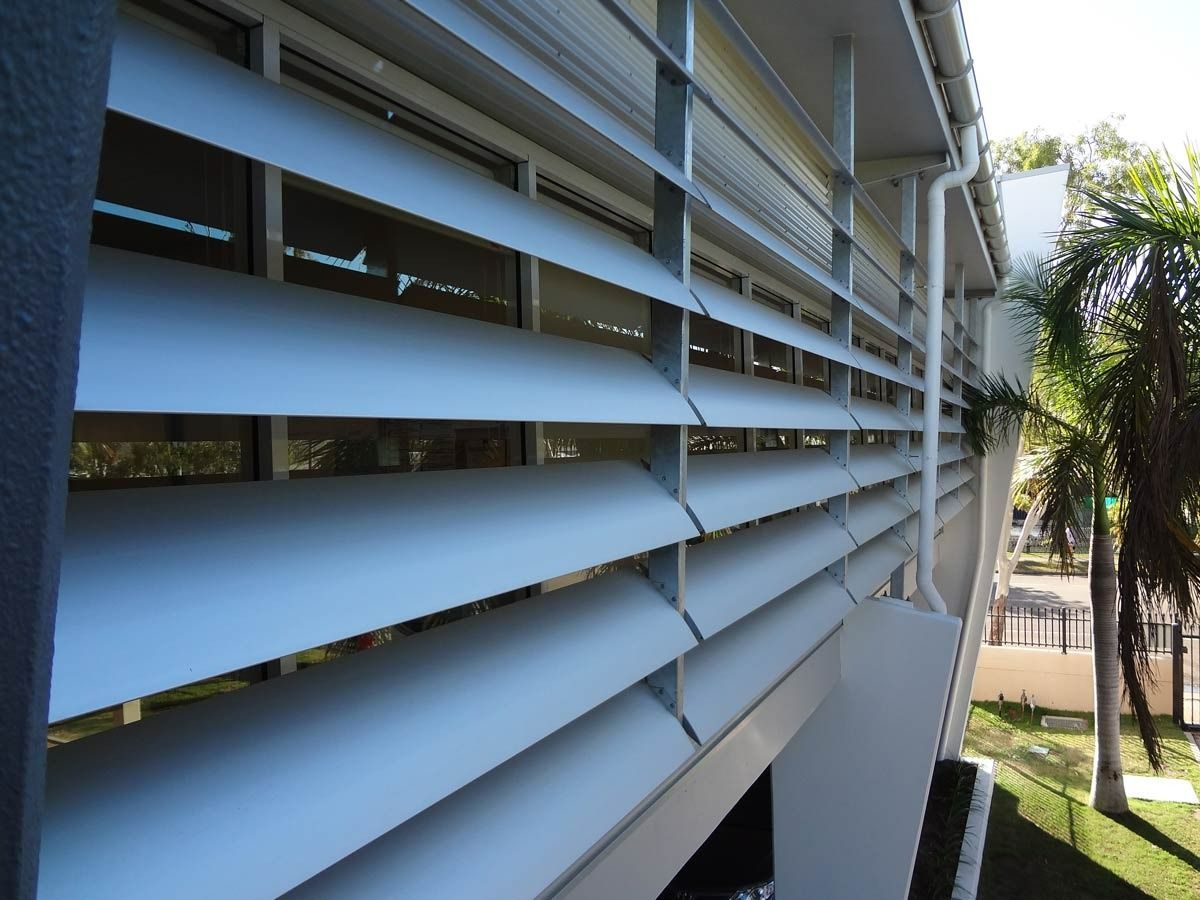 A Building With A Lot Of Shutters On It — Datco Aluminium Pty Ltd In Byron Bay, NSW