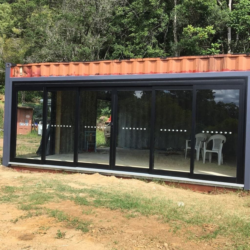 A Large Building With A Lot Of Windows And Chairs In Front Of It — Datco Aluminium Pty Ltd In Murwillumbah, NSW