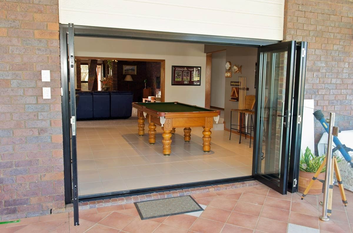 A Pool Table Is Sitting In A Room Behind A Glass Door — Datco Aluminium Pty Ltd In Murwillumbah, NSW