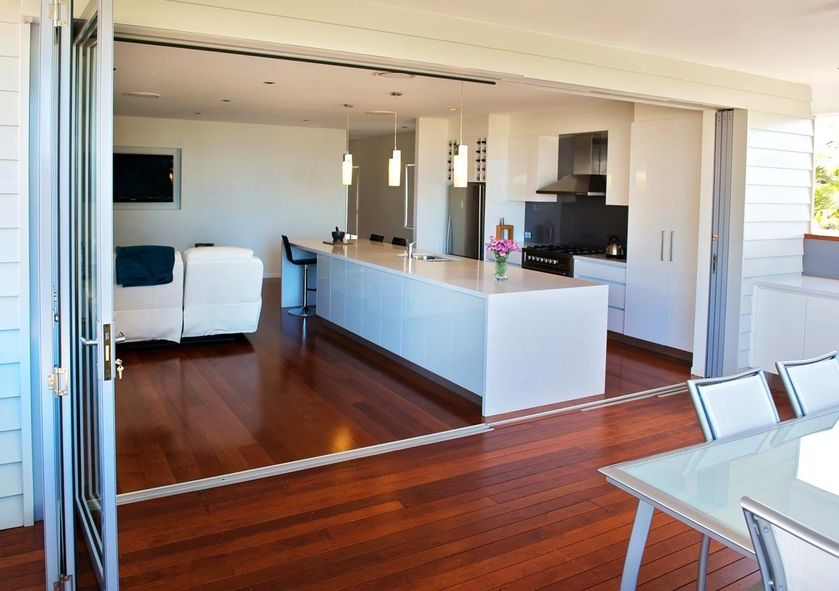 A Kitchen With A Large Island And A Dining Table — Datco Aluminium Pty Ltd In Murwillumbah, NSW