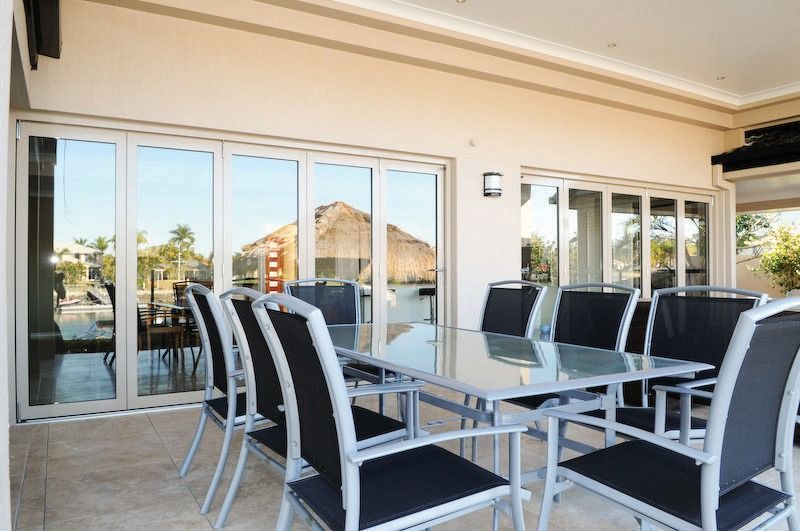 A Patio With A Table And Chairs And A Lot Of Windows — Datco Aluminium Pty Ltd In Casino, NSW