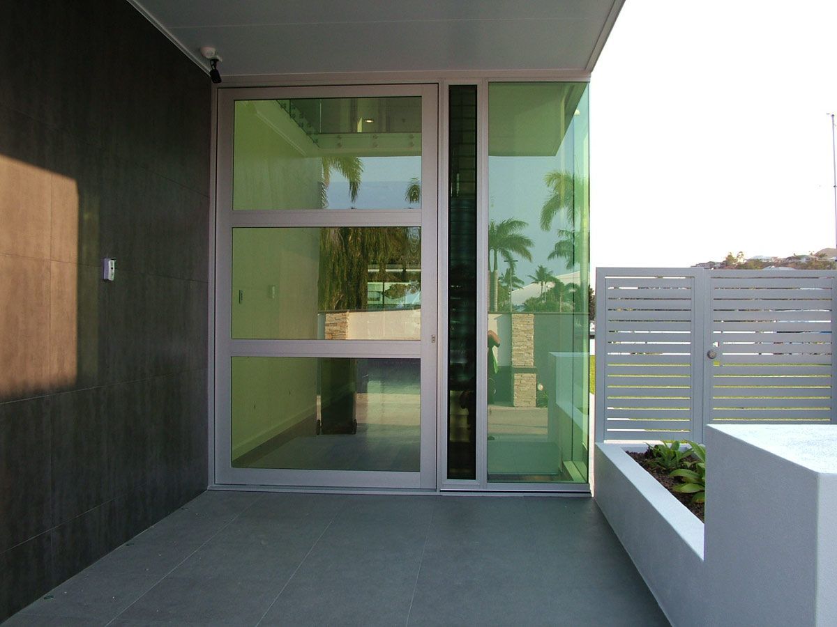 A Modern House With A Large Glass Door — Datco Aluminium Pty Ltd In Murwillumbah, NSW
