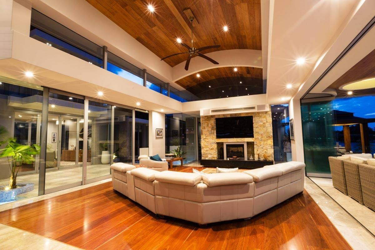 A Living Room With A Large Couch And A Fireplace — Datco Aluminium Pty Ltd In Murwillumbah, NSW