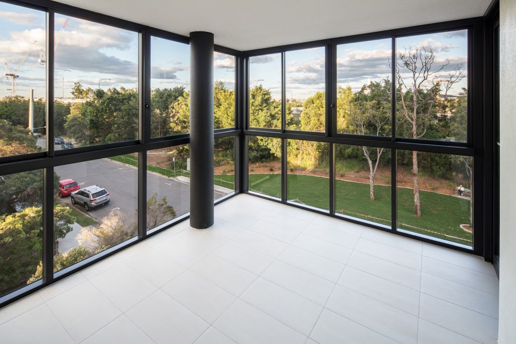 An Empty Room With A Lot Of Windows And A View Of A Park — Datco Aluminium Pty Ltd In Murwillumbah, NSW