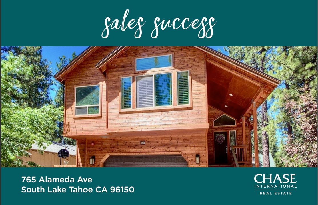 A dining room with a table and chairs and a wooden staircase.