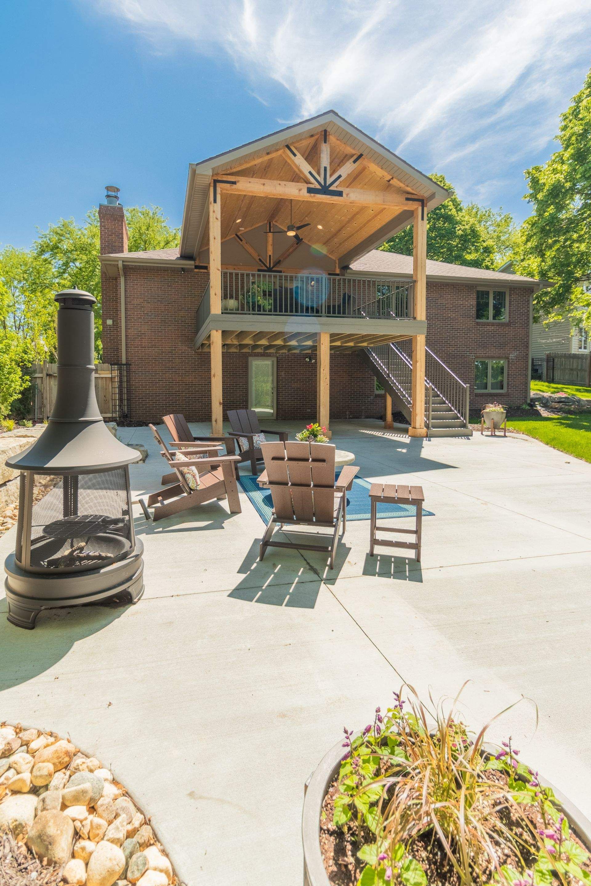 There is a fireplace in the backyard of a house.