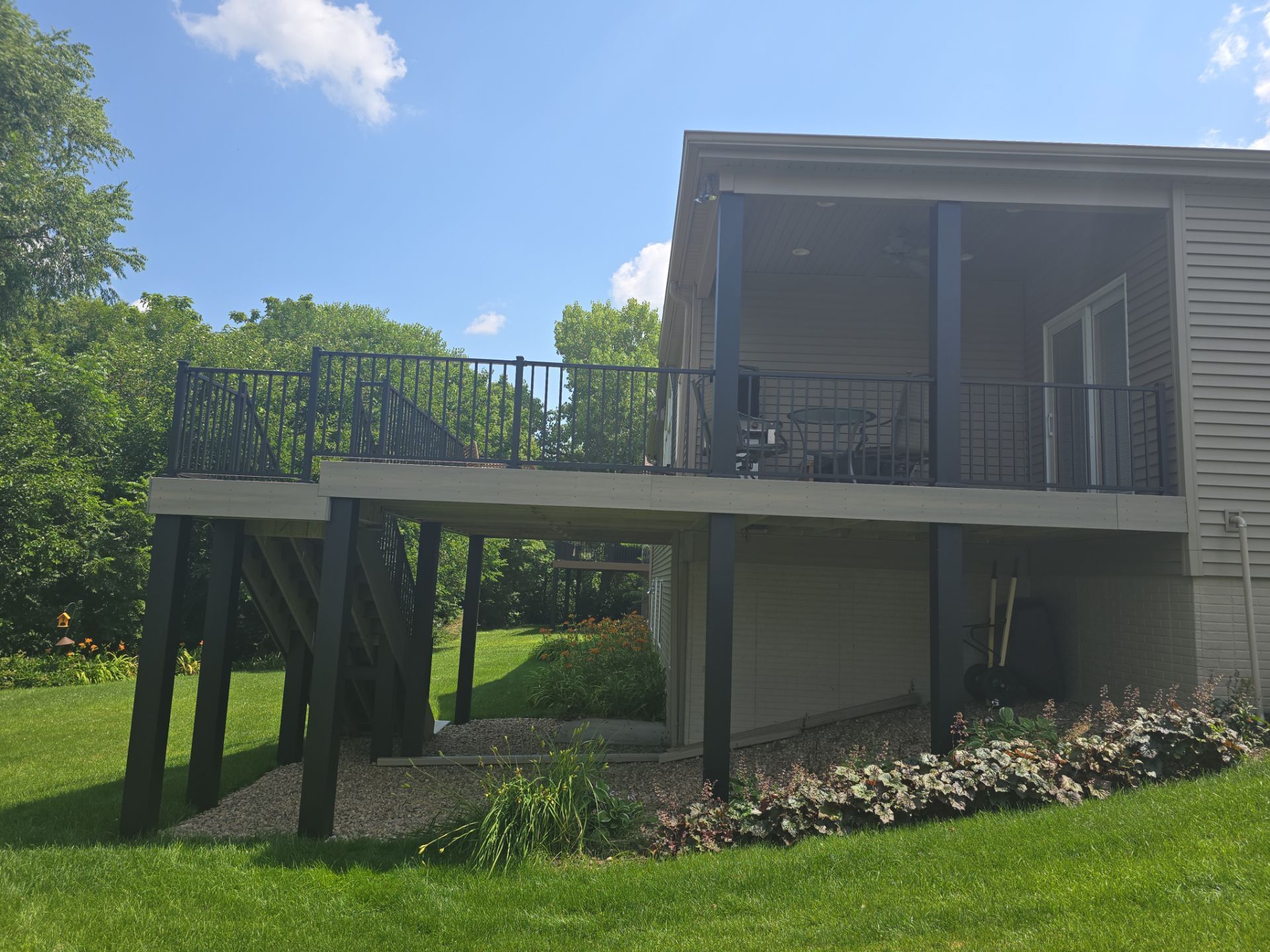 A house with a large balcony on the side of it.