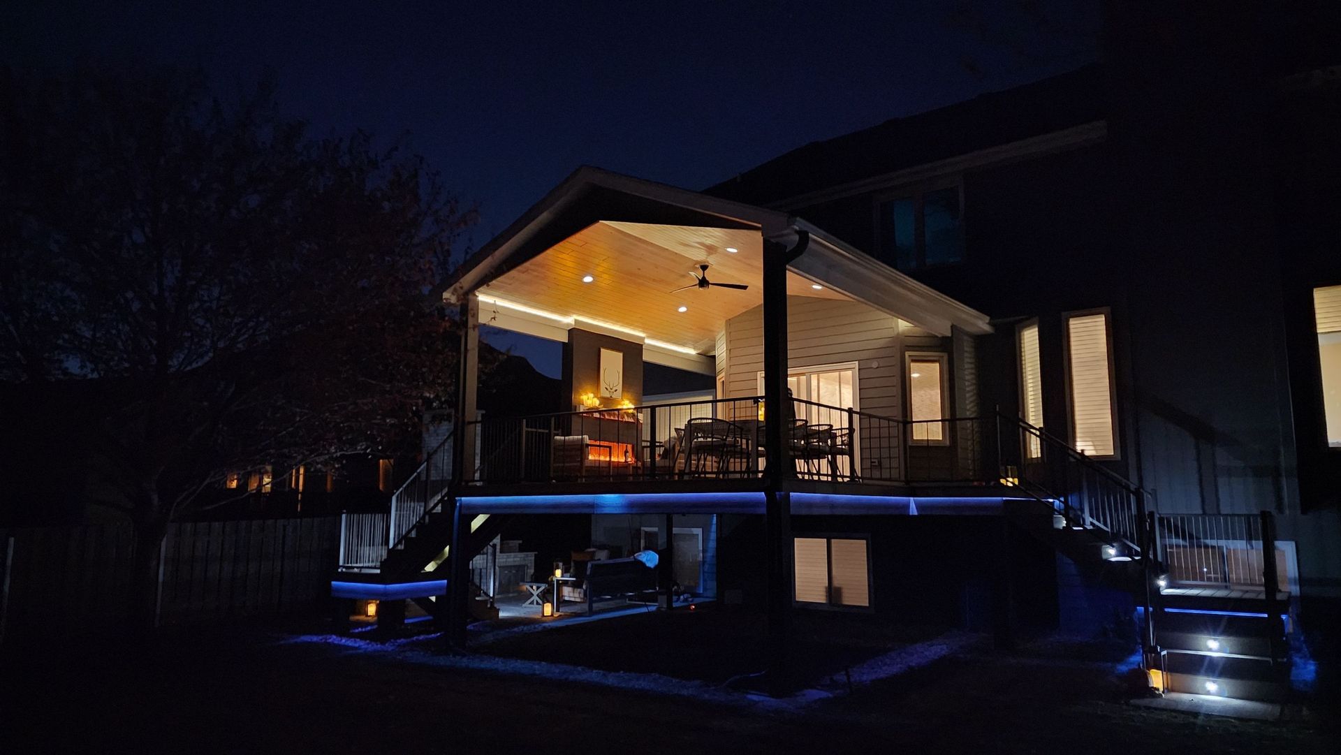 The back of a house is lit up at night.