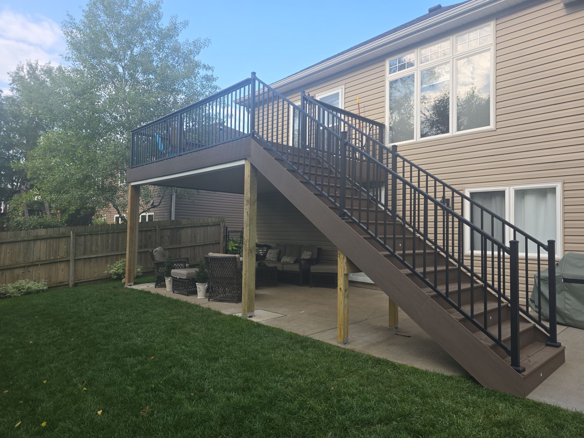 A house with a deck and stairs leading up to it