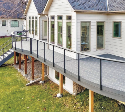 An aerial view of a house with a deck and stairs.