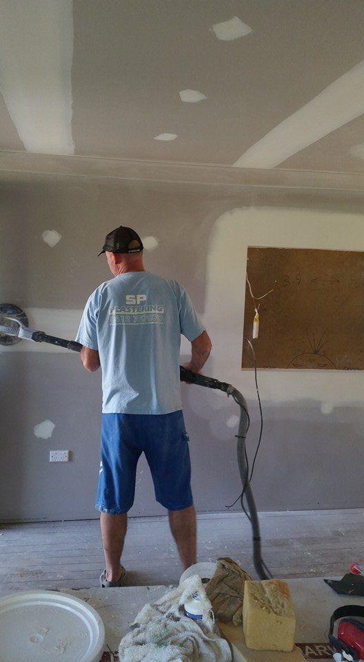 Man Polishing The Wall — Builders in Salt Ash, NSW