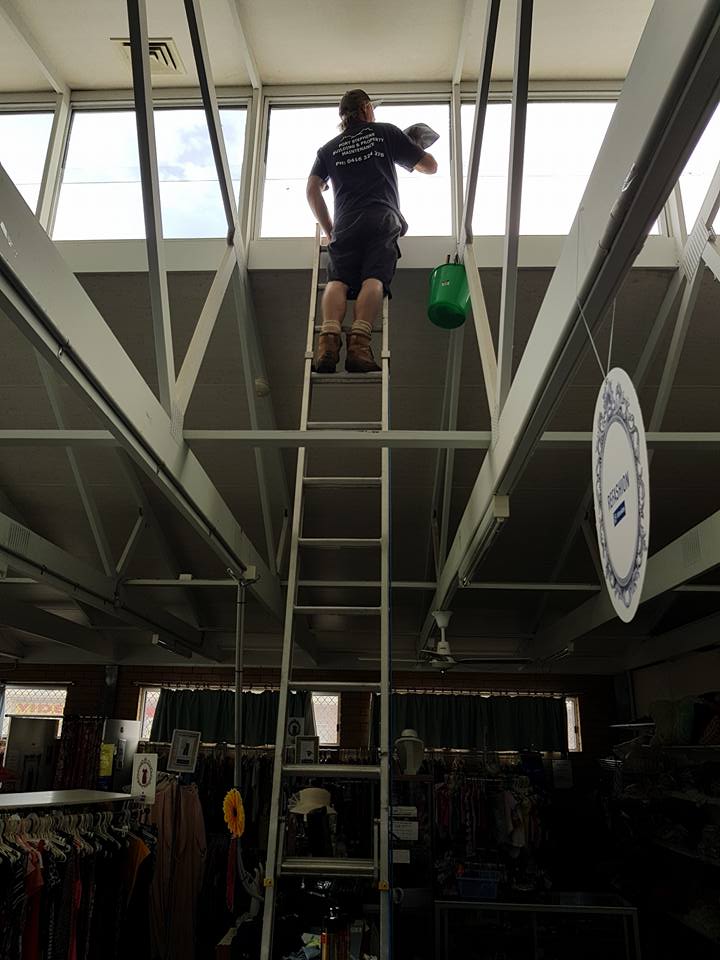 Man Fixing Ceiling Windows — Builders in Salt Ash, NSW