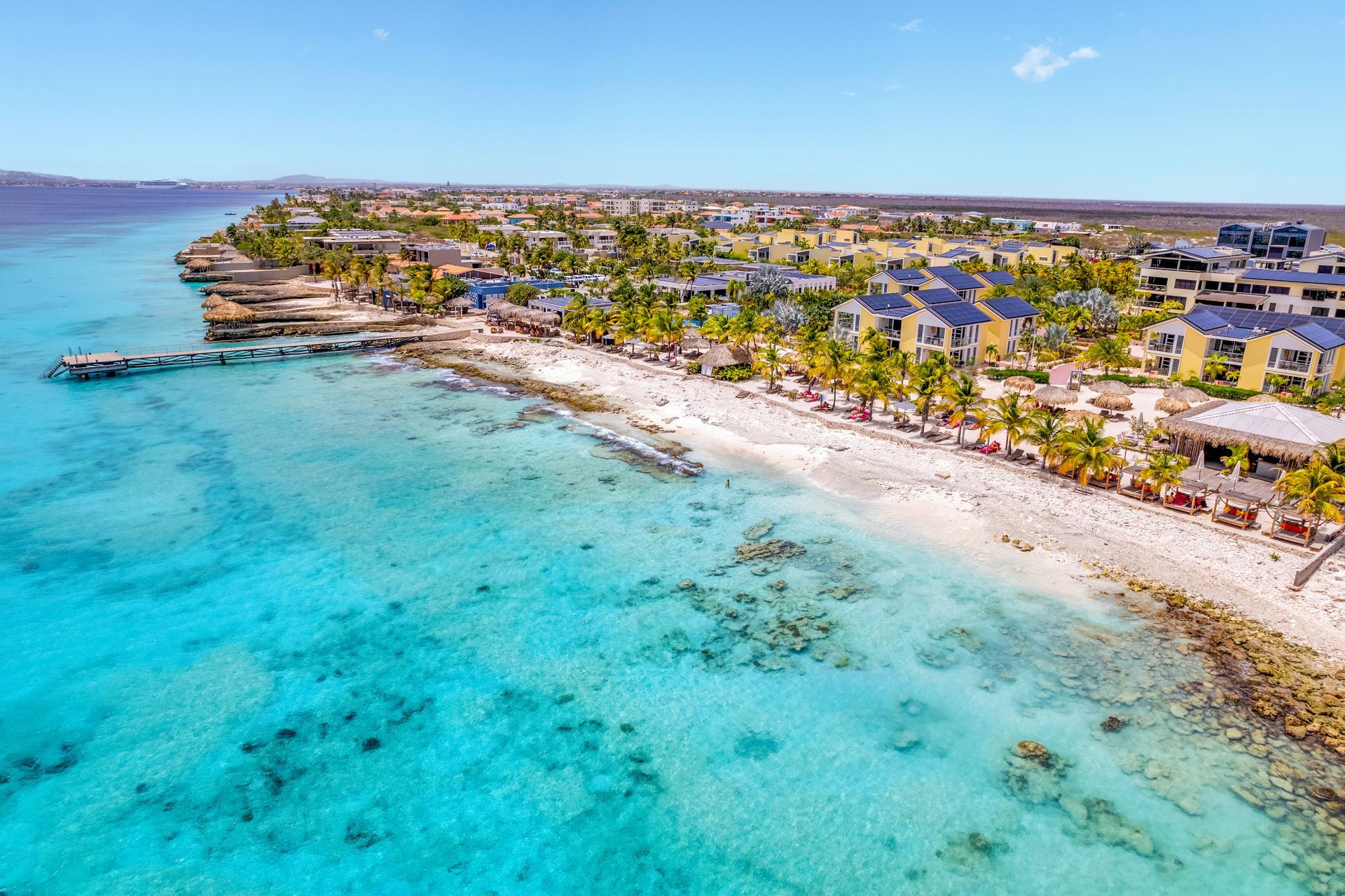 An aerial view of a dock in the middle of the ocean. Bonaire