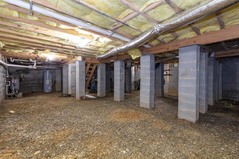 Crawl space with concrete beams providing structural support.