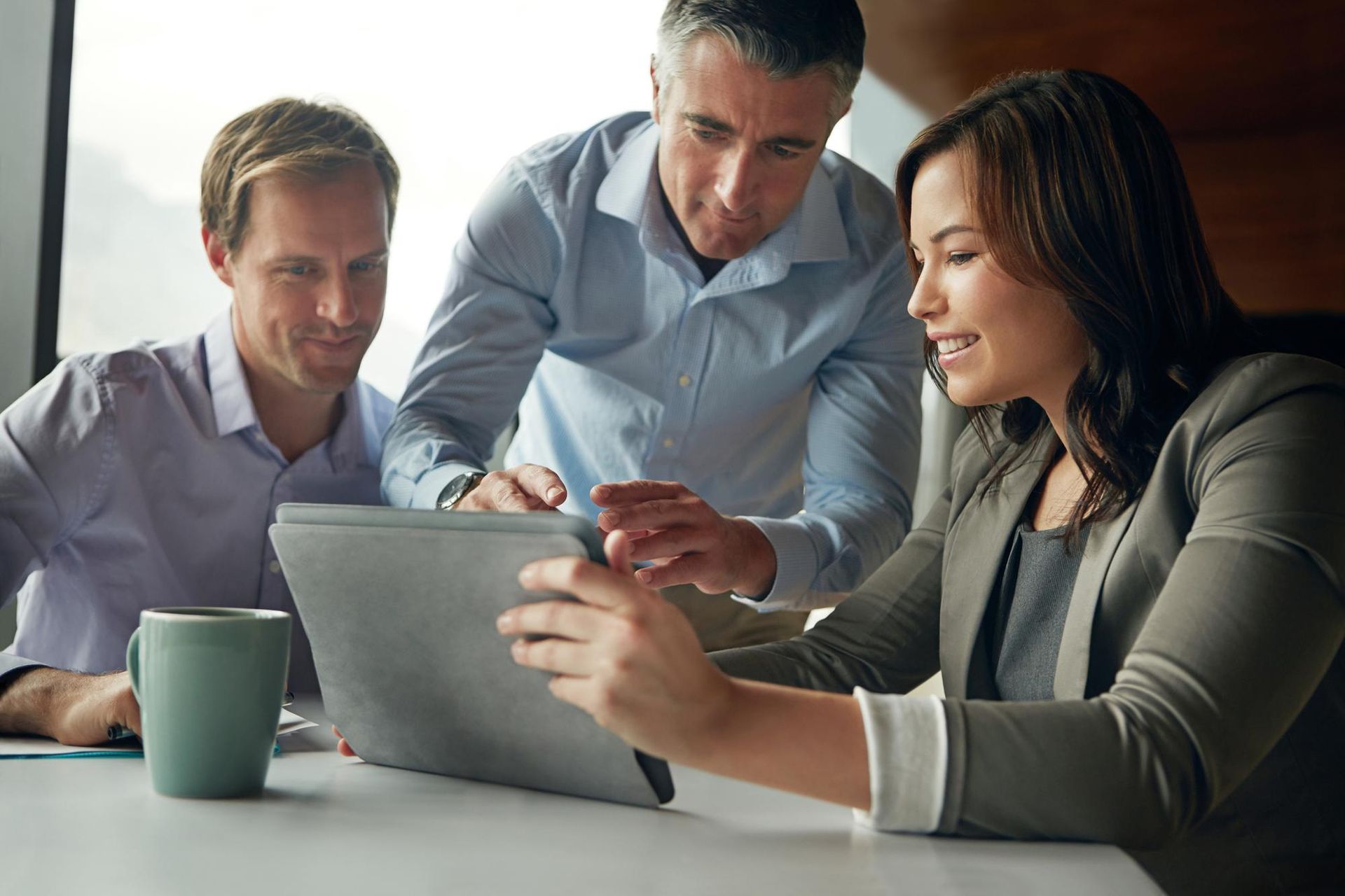 A group of people are looking at a laptop computer.