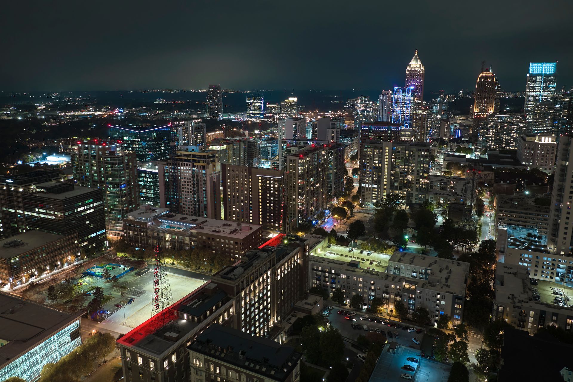 A person is holding a camera lens over a river.