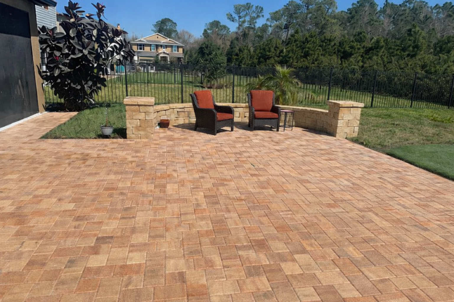 Flagstone's Union Cream/Orange/Brown paver patio with Stonegate Tumbled Cream/Beige sitting Wall and Columns
