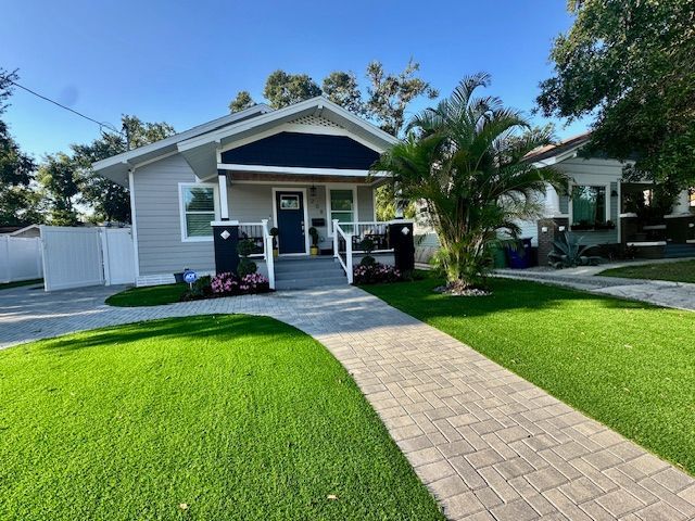 Tremron 4x8 Pavers in Granite laid in a Herringbone pattern with a Turf front yard