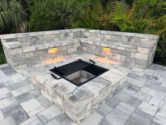There is a fire pit with sitting wall surrounding.