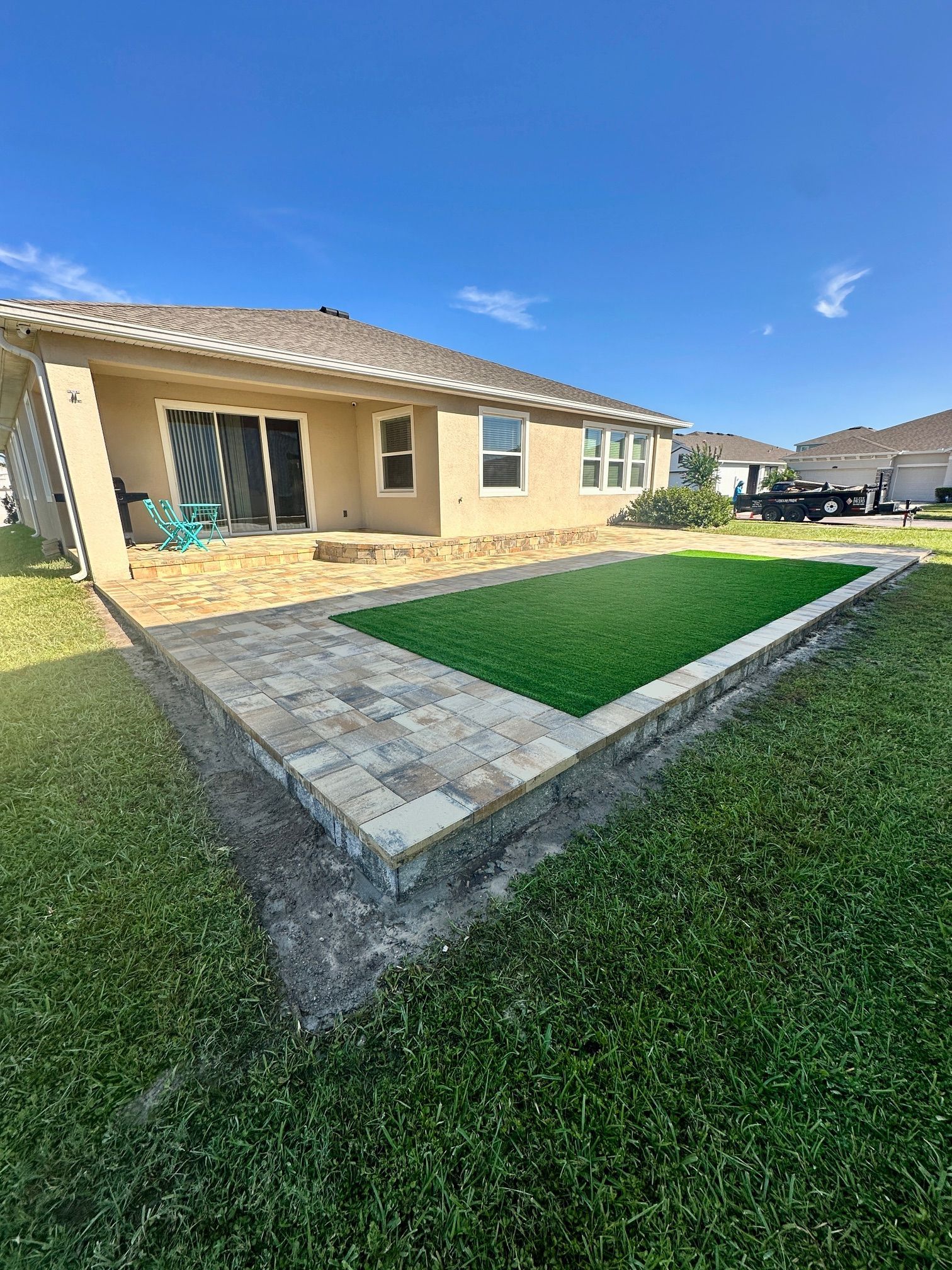 Cream Beige Charcoal Patio with Turf Inlay