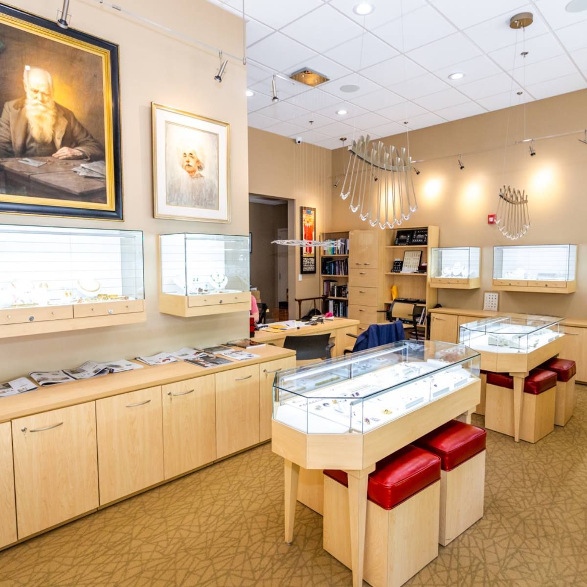 Bright jewelry store interior with display cases, wall art, and overhead lighting