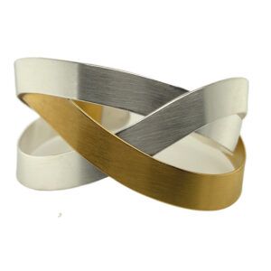 Interwoven metallic gold, silver, and white ribbon loops on a white background