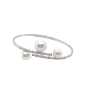Silver bracelet with three pearls on a white background