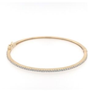 Gold hoop bracelet with a row of small clear stones along the front edge