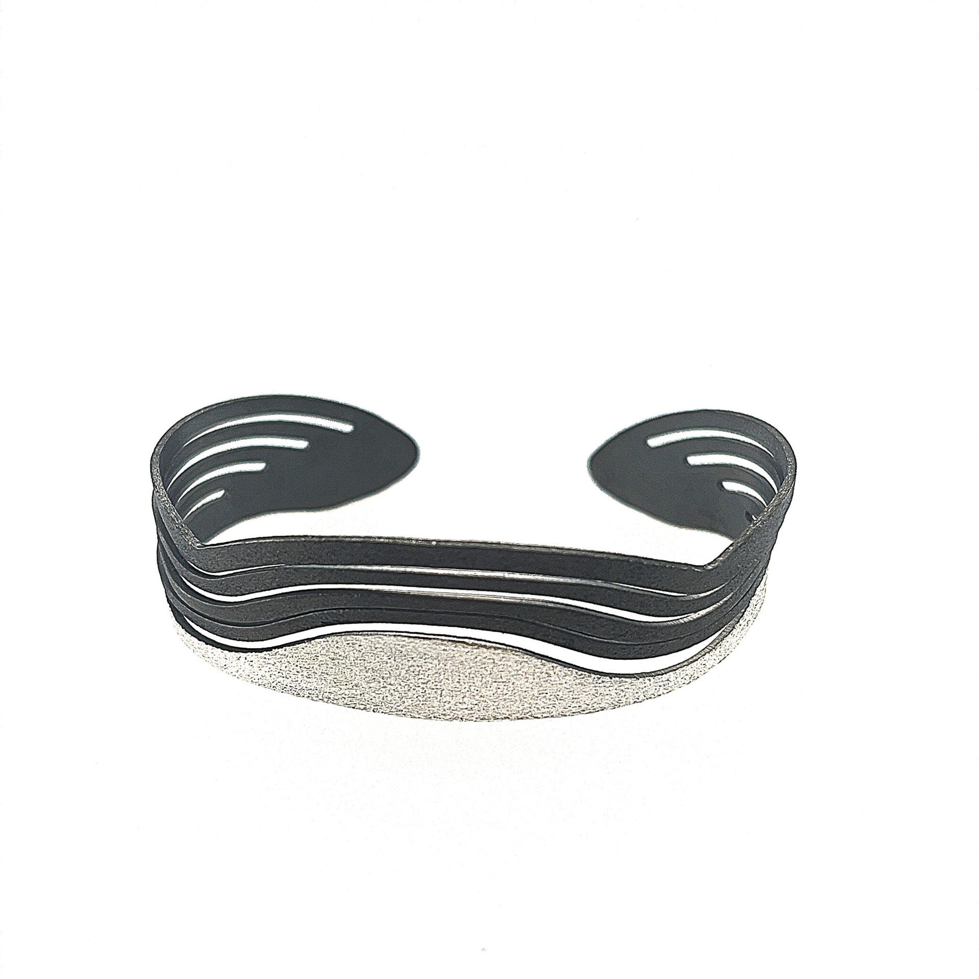 Black curved beard guard with elastic band and textured inner lining on white background