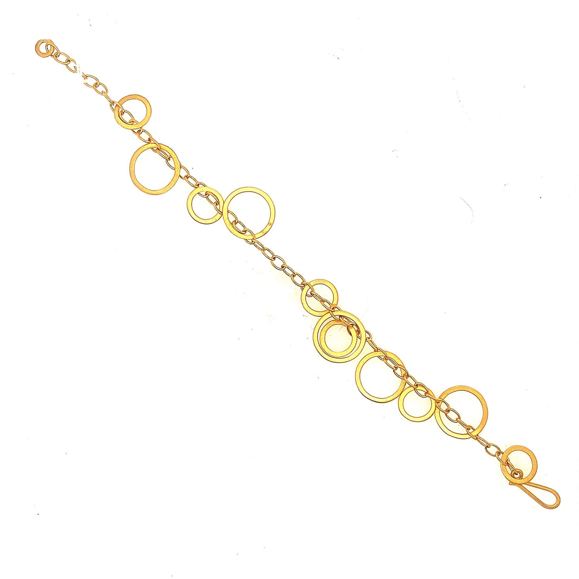 Gold bracelet with linked circles on a white background