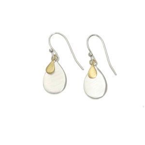 Pair of silver teardrop earrings with small gold accents on a white background